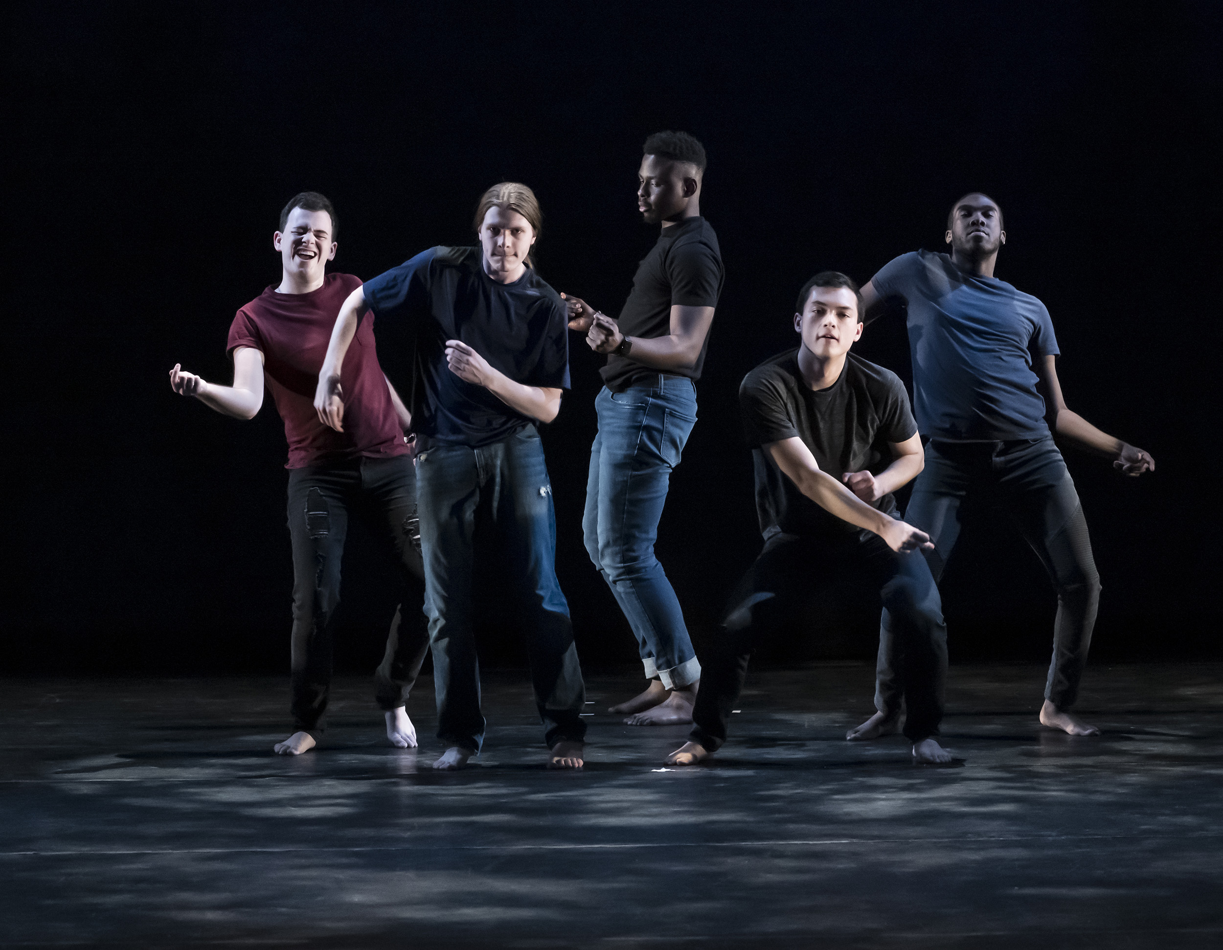 Five male college students dancing on stage