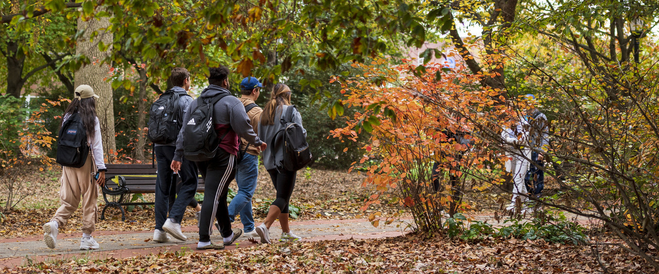 Three UD Students walking to class in UD gear