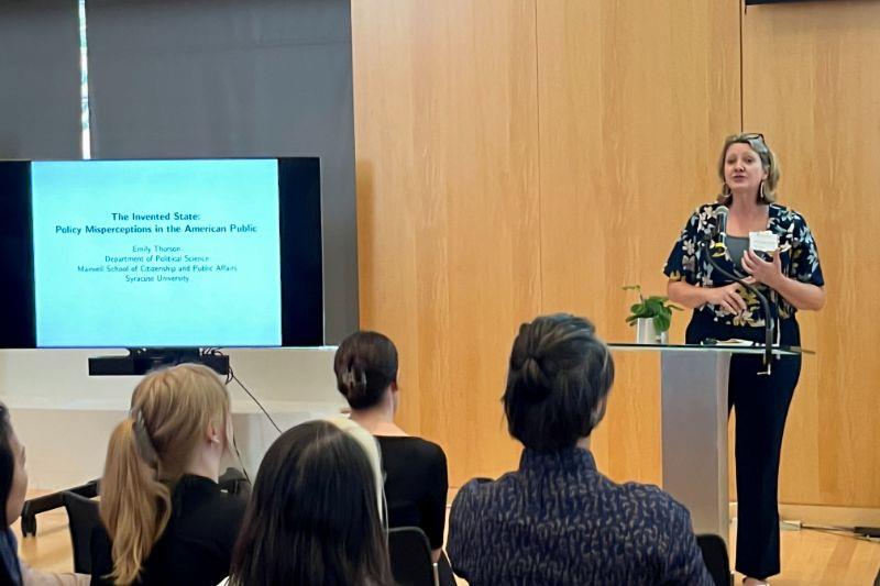 Author speaking to audience at a podium