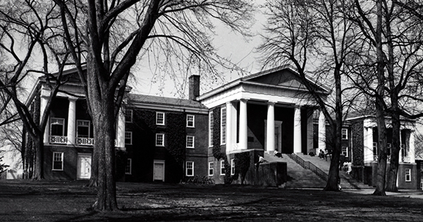 Black & white image of a historic academic building on a college campus