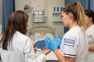 Nursing simulation with UD students in white medical frocks