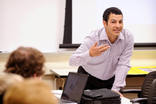 An instructor lectures to students inside a classrooom.