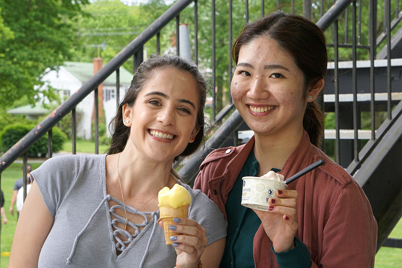 Two college students holding ice cream