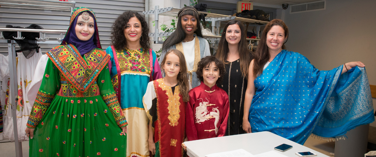 Festival of Nations, five adult women with two children in colorful ethnic wardrobe