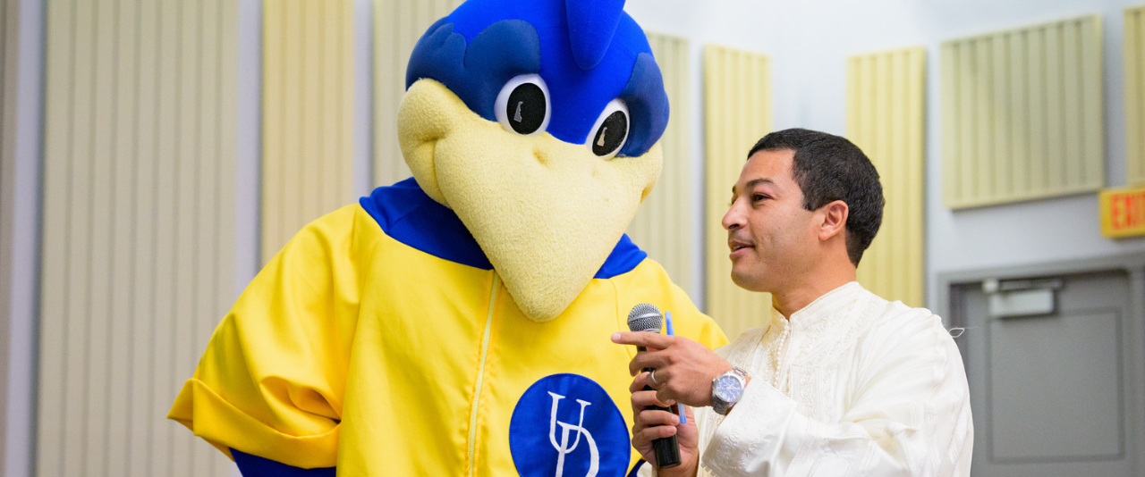 YouDee Bluehen mascot with ELI student