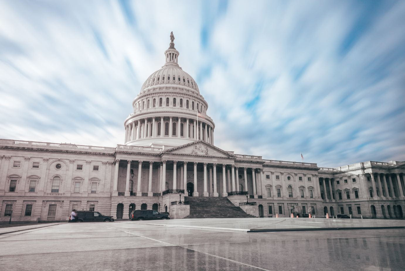 U.S. Capitol Building against a blue sky with puffy white clouds