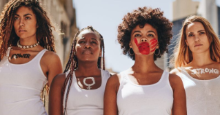 Group of women in white tank tops with domestic violence symbols painted on them