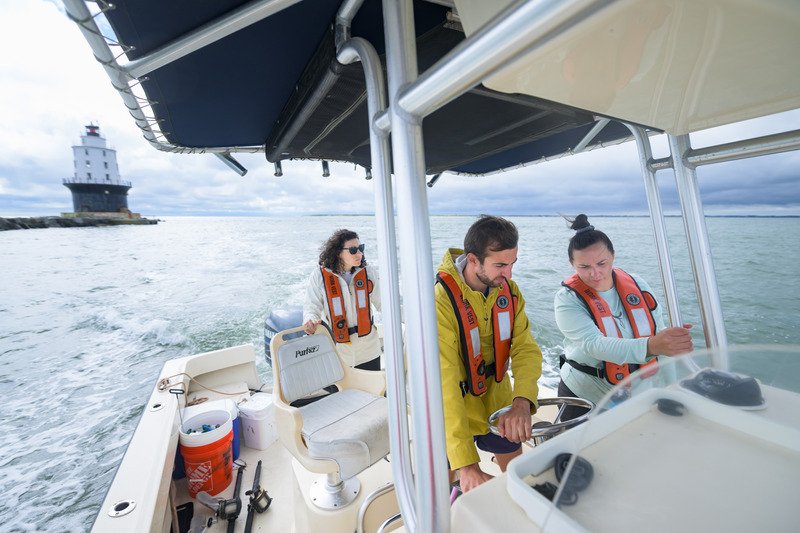 Students operating a boat on Delaware Bay