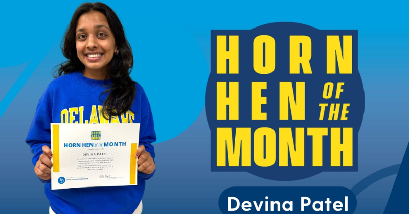 Devina Patel holding the Horn Hen of the Month certificate