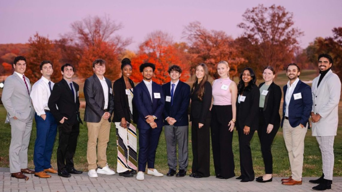 Group photograph of the 2024-2025 Siegfried Fellows standing outside