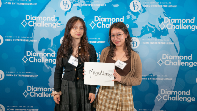 Team posing against the Diamond Challenge banner