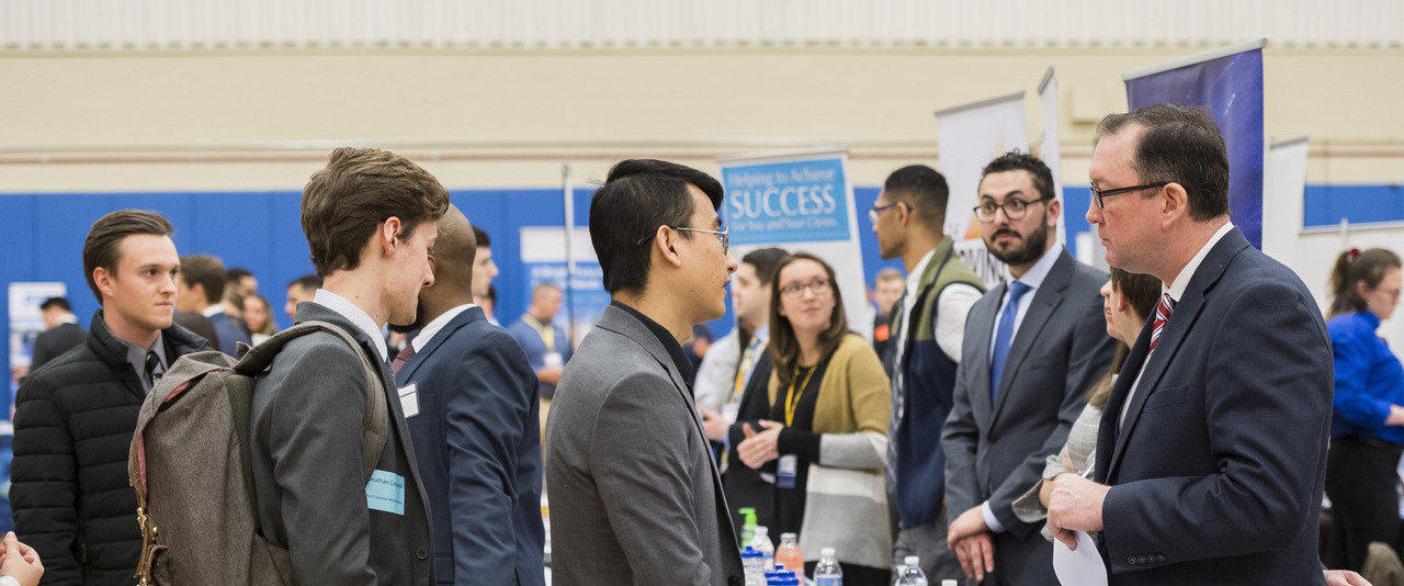 Students speaking with employers at a Career Fair event