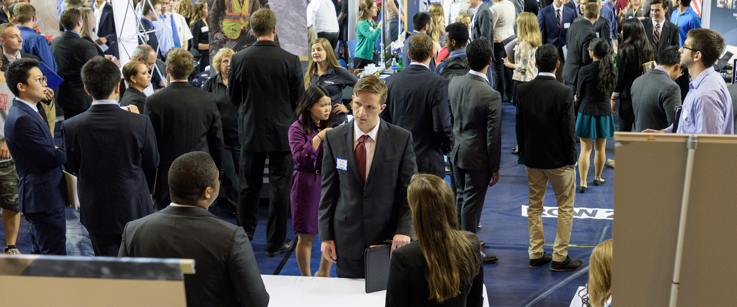 Numerous employers speak with a variety of students during a campus Career Fair