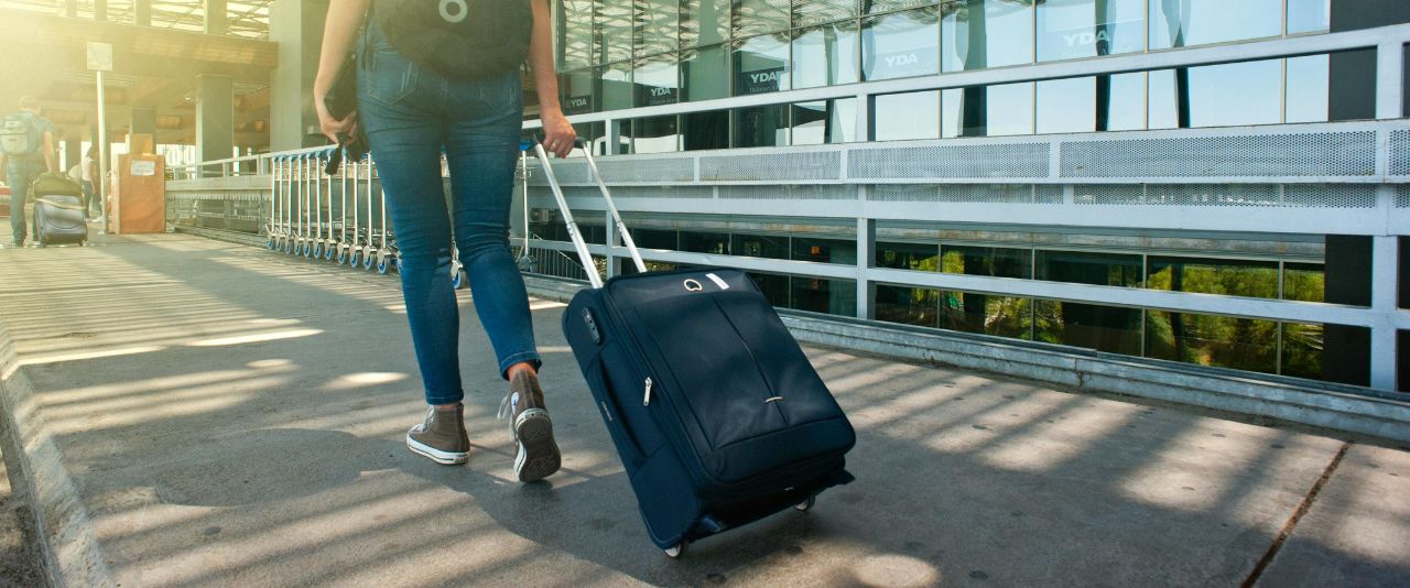 Student pulling a suitcase