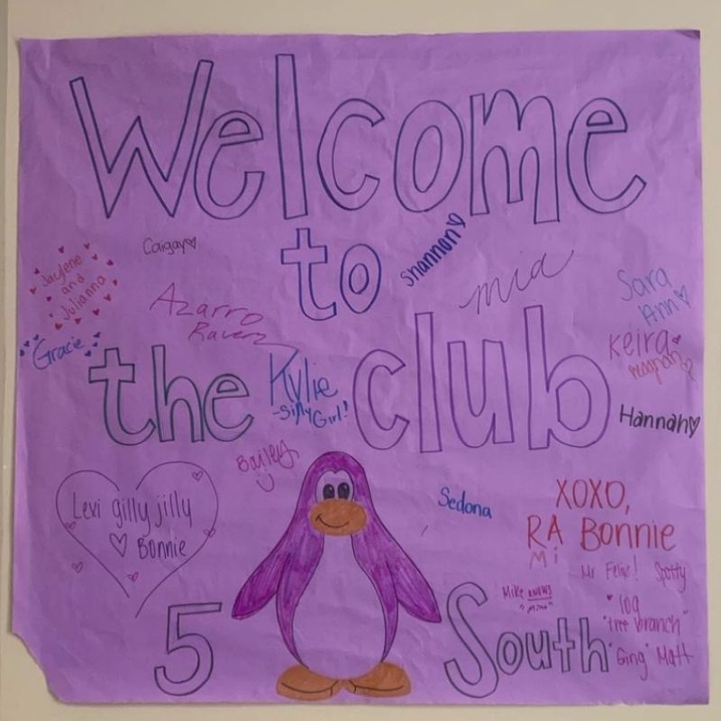 Purple poster with a drawing of a penguin that reads "Welcome to the Club"