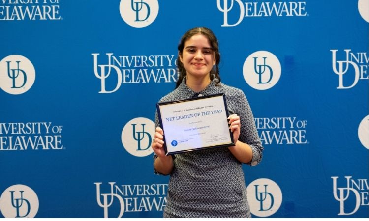 Student holding award certificate