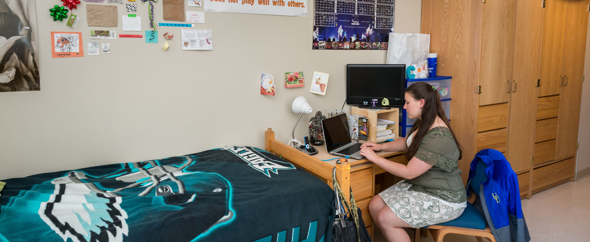 A student works on a laptop in a room in George Read