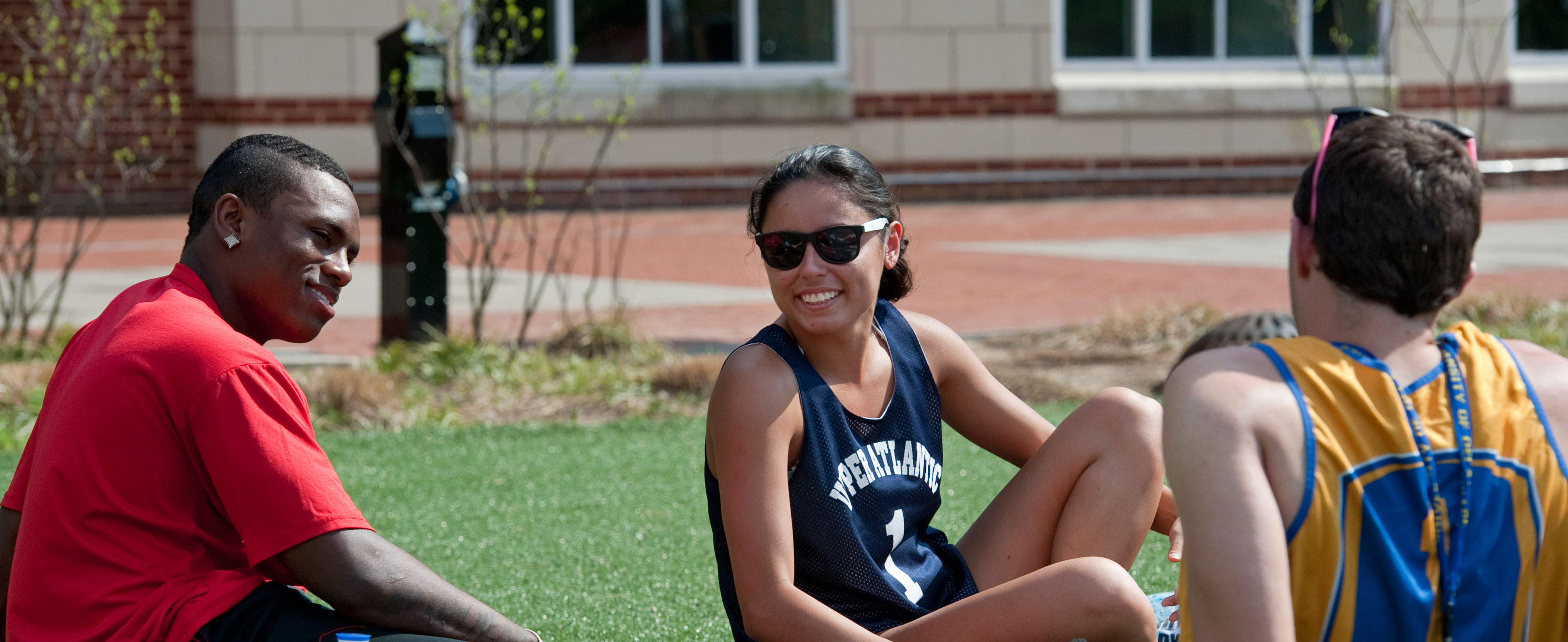 Students sitting outside on the turf