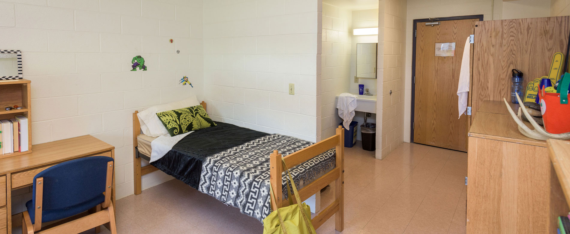 A furnished and decorated Ray Street room with a bed, desk, dresser and wardrobe