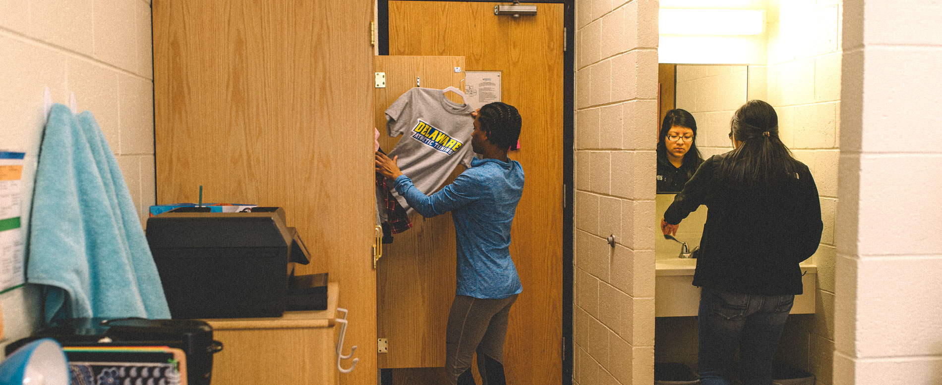 Student takes clothing out of a wardrobe in a Ray Street room