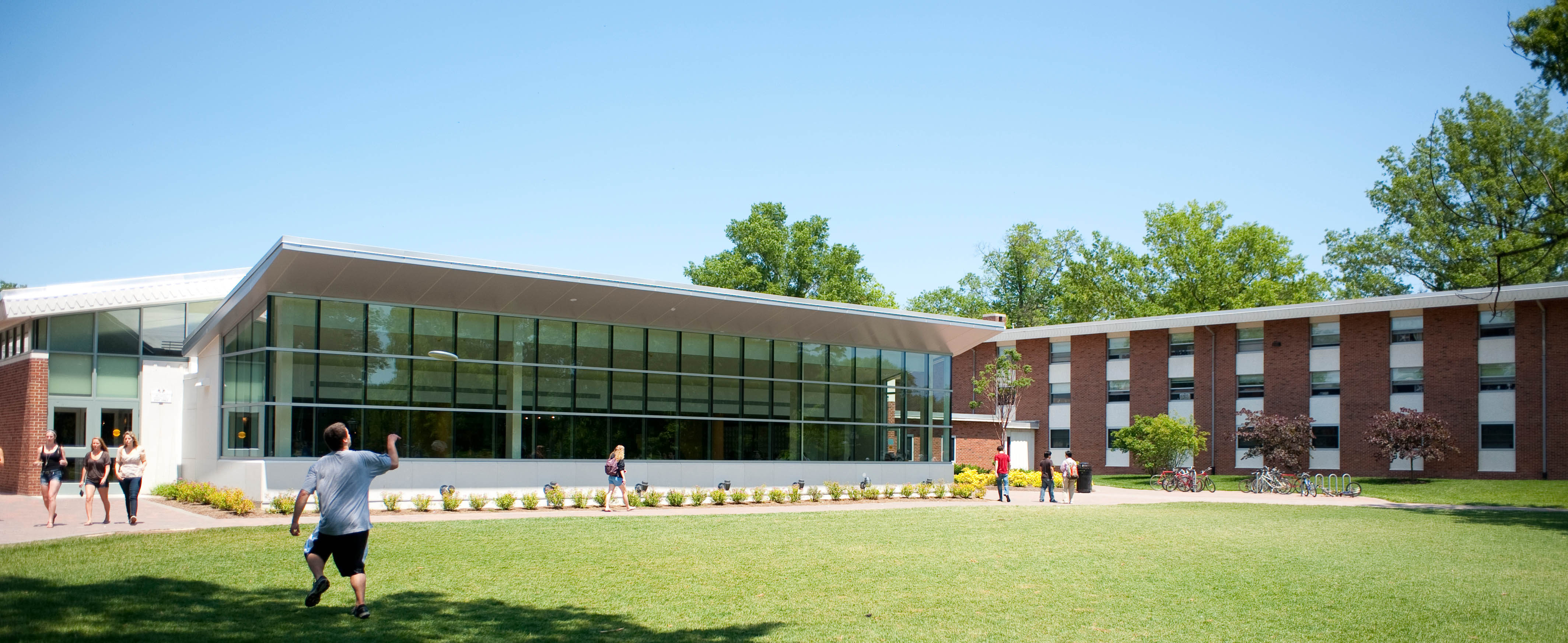 Students walking past the exterior of Russell Dining Hall