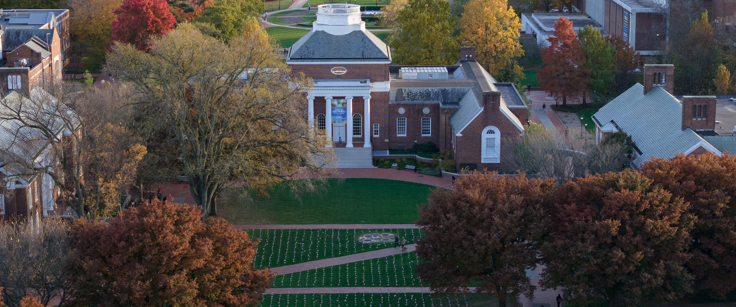 Memorial Hall faces the Green where a grid of American flags are planted for Veterans Day