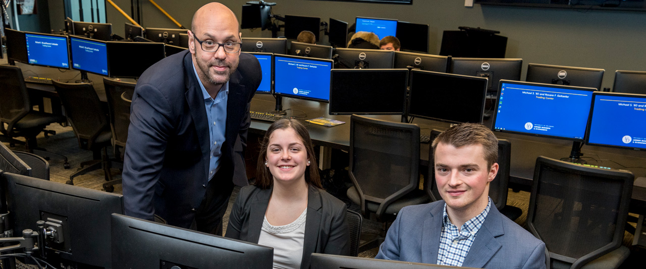 Students and faculty working in the Michael and Rosann Geltzeiler Trading Center