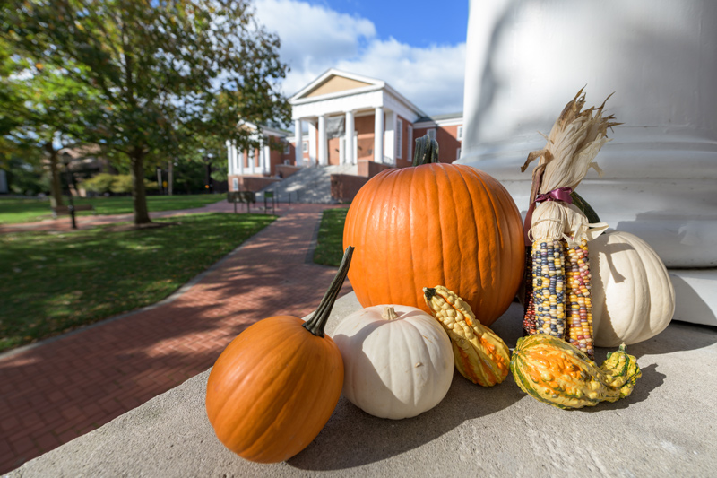 An exterior photo of Old College Hall with pumpkins and gourds