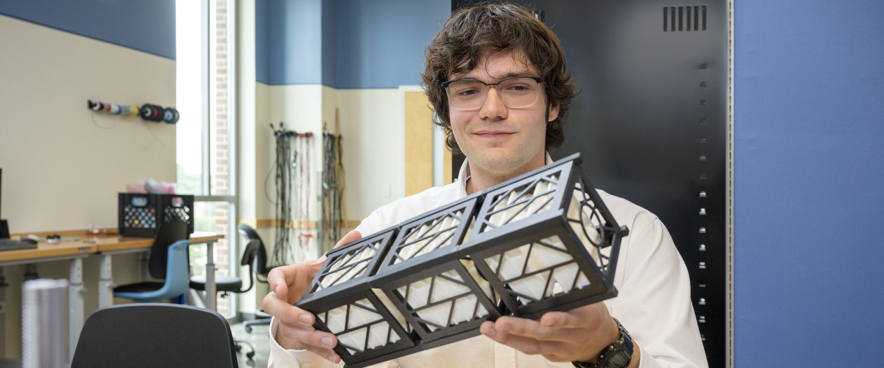 UD junior Timothy “TJ” Tomaszewski holding the CubeSAT