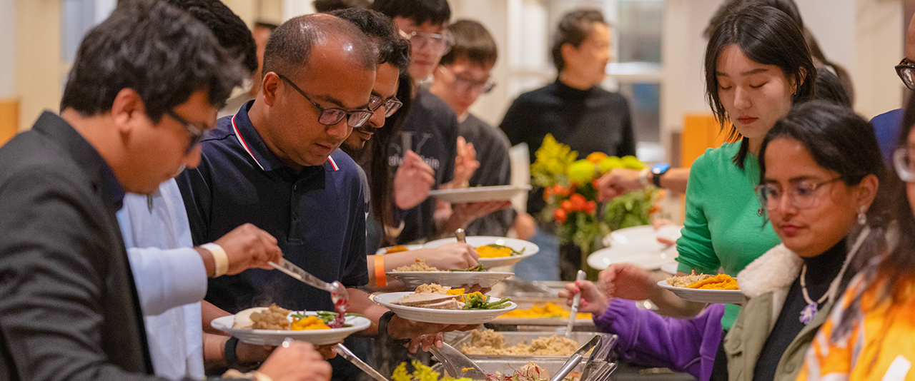 International students, scholars and their families enjoy a traditional Thanksgiving dinner with turkey and all of the fixings at an event hosted by the Center for Global Programs and Services.