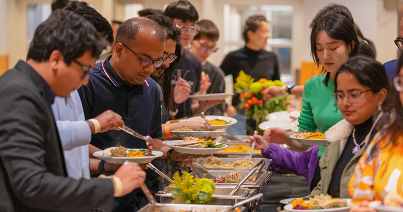 International students, scholars and their families enjoy a traditional Thanksgiving dinner with turkey and all of the fixings at an event hosted by the Center for Global Programs and Services.