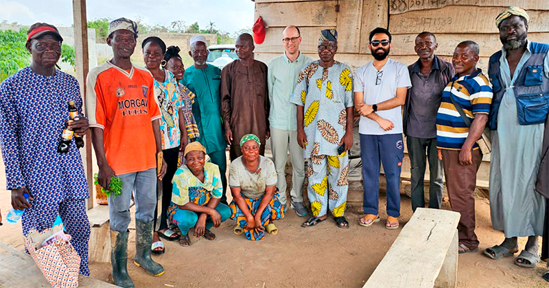 Davis and Khan with Nigerian farmers.