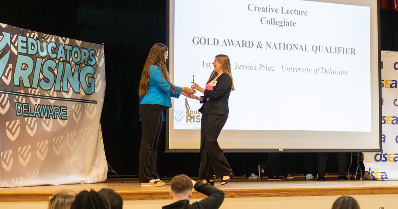 Jessica Price, a University of Delaware English Education major, accepts the first place gold award in the Delaware Educators Rising Creative Lecture collegiate competition. 