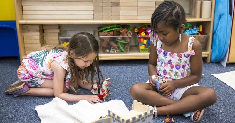 Preschool children play with figurines and horses at the College of Education and Human Development’s Early Learning Center.