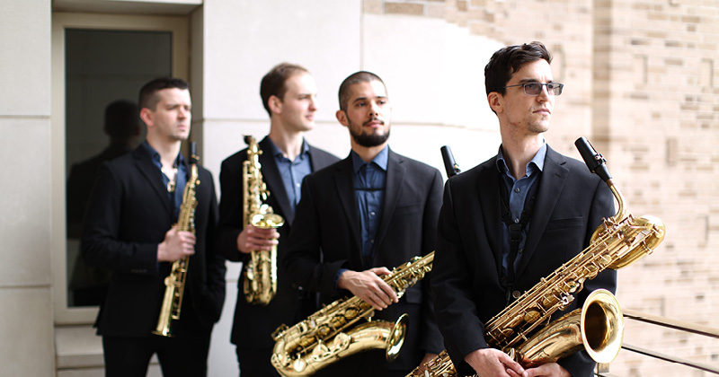 Four members of the Sinta Quartet holding saxaphones