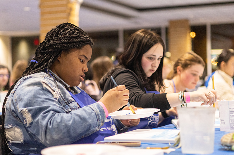 Students painting at a Perkins Live Paint Night