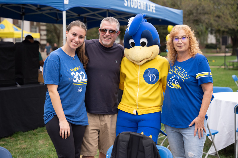 PFW-Kick_Off-Check_In-MR-100623 A family smiles and poses with Baby Blue