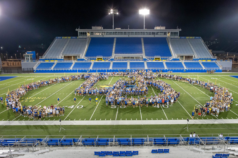 Gameday-101-082921 Students gather together to form the letters "UD" on the football field