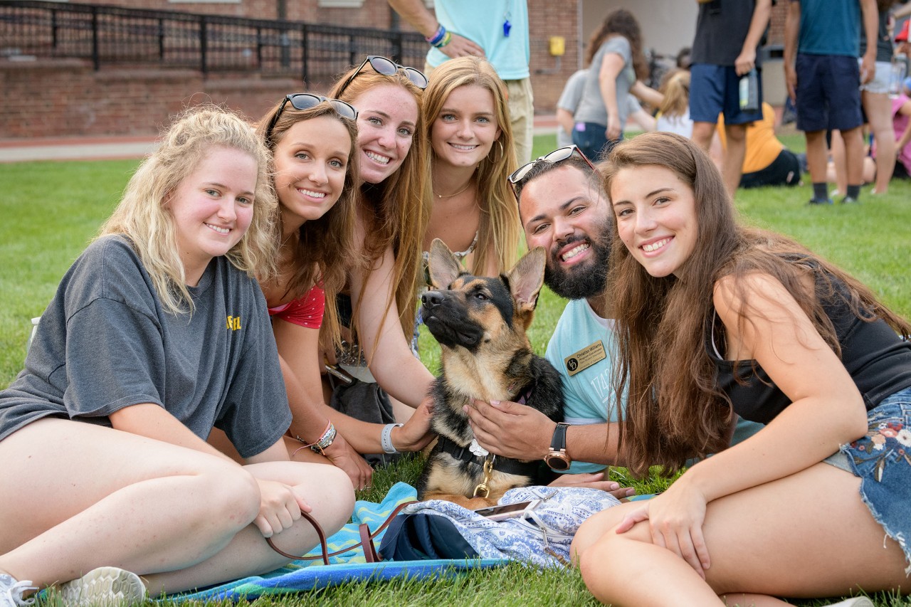1743-Puppy_Playdate_On_The_Green-082618 Puppy raiser students on a blanket outside