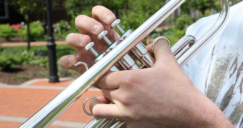 Various students using instruments in and around Center for the Arts.