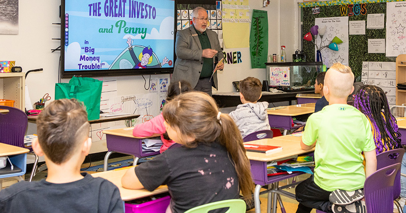 Third-graders are quick to suggest answers to banker Randy Kunkle’s questions during Teach Children to Save Day at R. Elisabeth MacClary Elementary in Newark.  