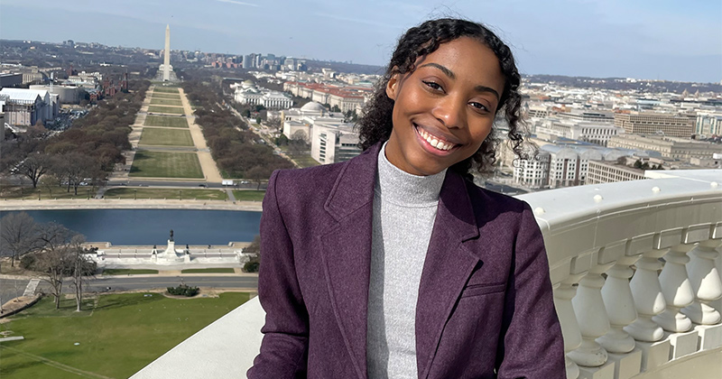 Anaya Harrison, who graduated with her bachelor's degree in political science and public policy in May 2023, spent her last semester studying and interning in the nation’s capital. She stands at the top of the Capitol Building dome in this photo, with the National Mall and Washington Monument in the background.