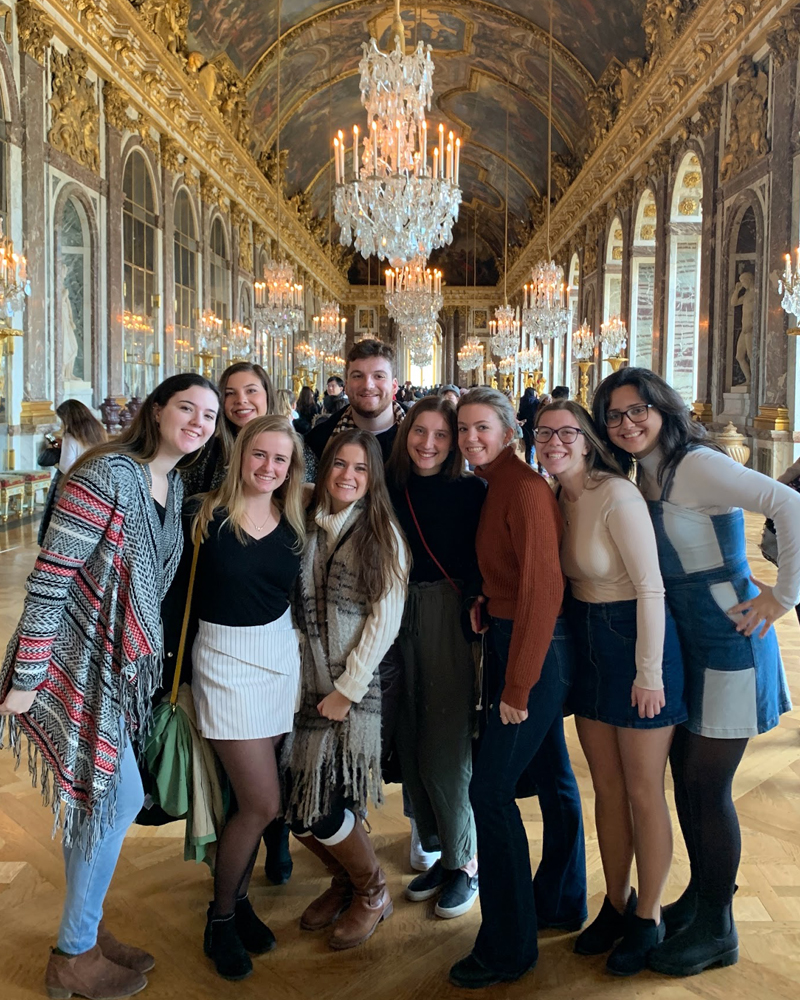 A group of Winter 2020 Paris biological sciences students pose in the Hall of Mirrors at the Château de Versailles.