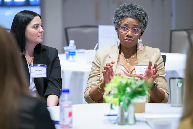 Alison Travers, assistant director of UD’s School Success Center (left) listens as Chéryl Wilmore, program coordinator for Wilmington University’s Doctor of Education in Organizational Leadership, Learning and Innovation, speaks during a small group breakout session.