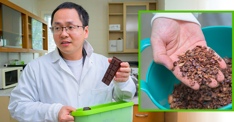 Juzhong Tan holds up a finished bar of whole bean chocolate. 