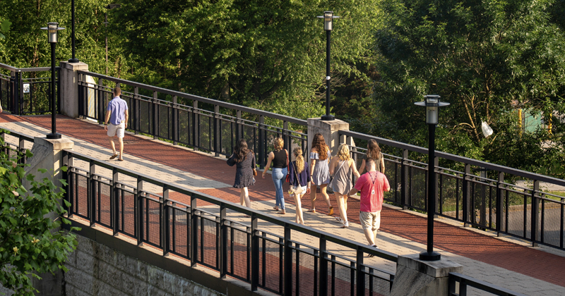 Students walking on the Laird Campus bridge