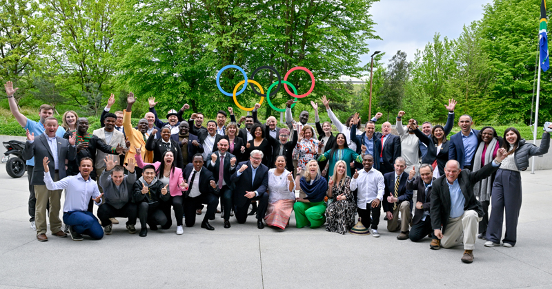 The 2024 ICECP graduating cohort and administrators celebrate outside of the International Olympic Committee headquarters in Lausanne, Switzerland.