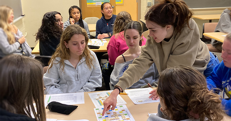 University of Delaware undergraduate Jillian Fader teaches chemistry students to play a quantum number board game