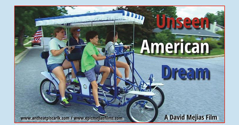 four people riding a surrey bicycle