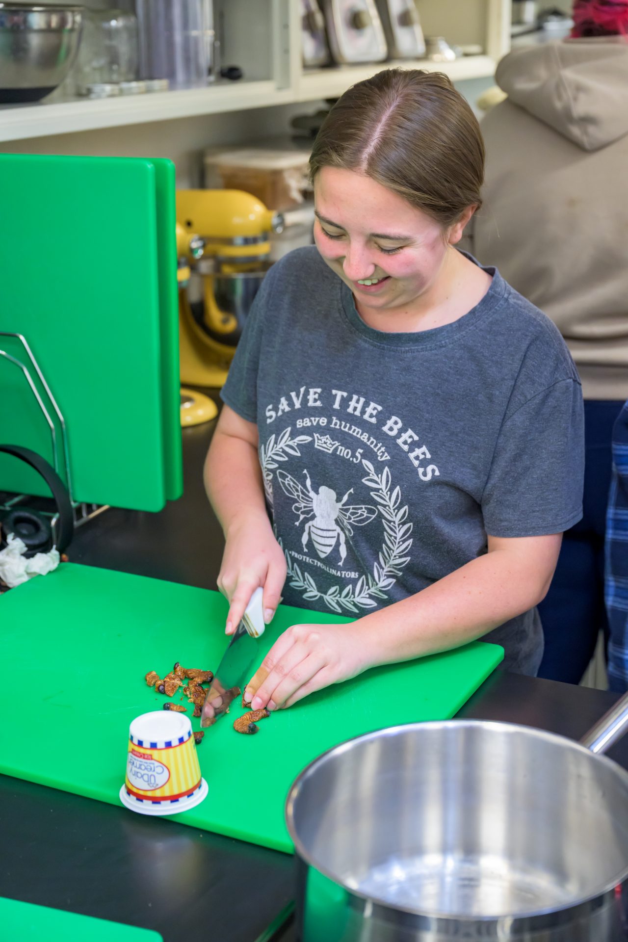A student dices Sago worms to incorporate them into a black bean chili. A student dices Sago worms to incorporate them into a black bean chili.